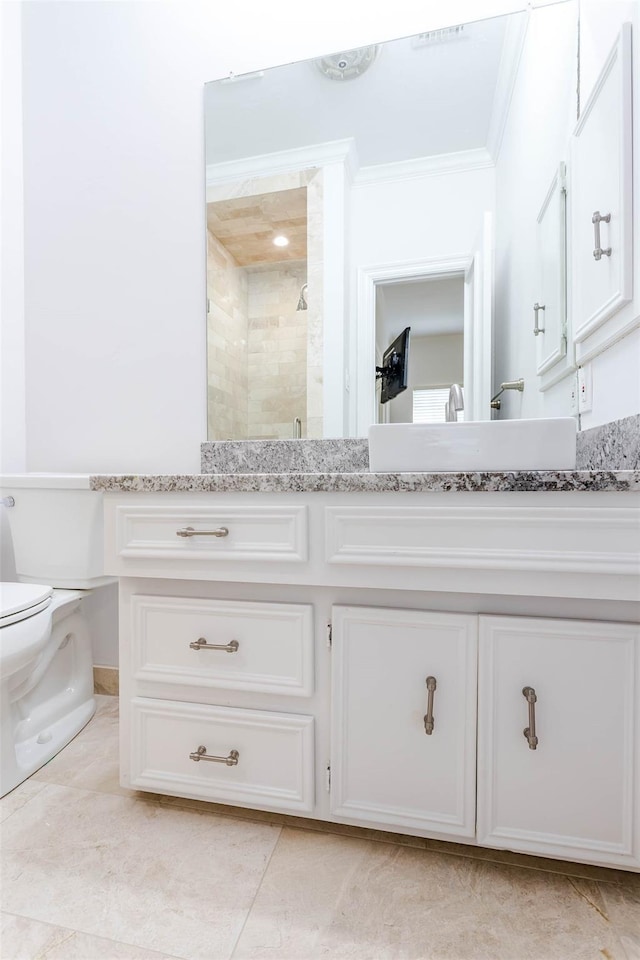 bathroom with toilet, ornamental molding, a stall shower, vanity, and tile patterned floors