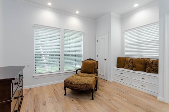 living area with light wood finished floors, crown molding, and recessed lighting