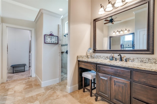 full bath with ornamental molding, a tile shower, vanity, and baseboards