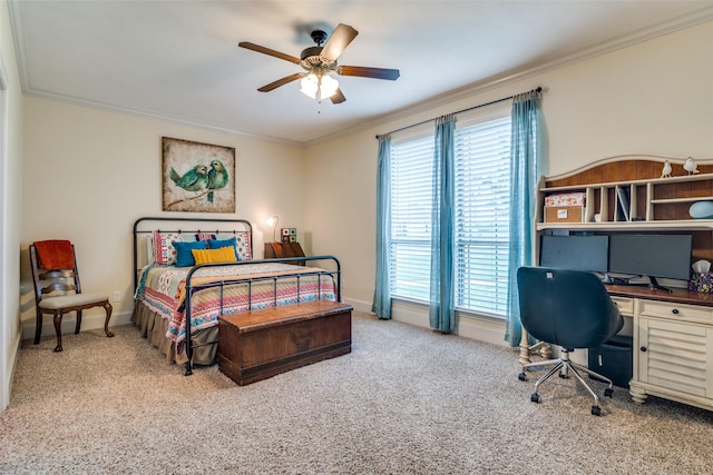 carpeted bedroom with ceiling fan, baseboards, and crown molding