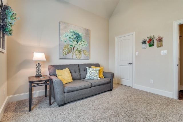 living room with lofted ceiling, carpet, and baseboards