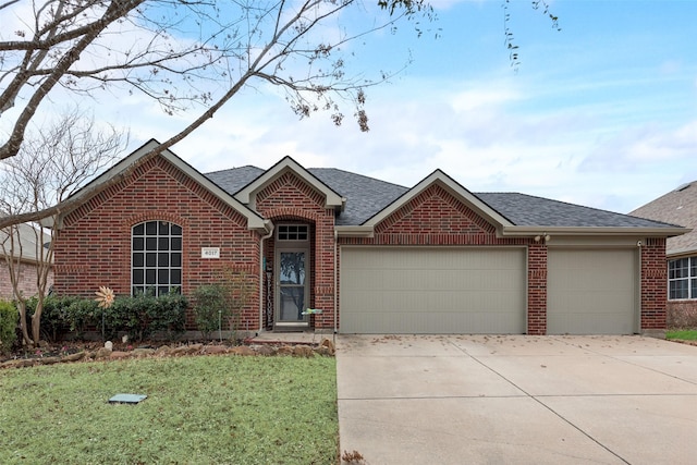 single story home with a garage, driveway, brick siding, and a shingled roof