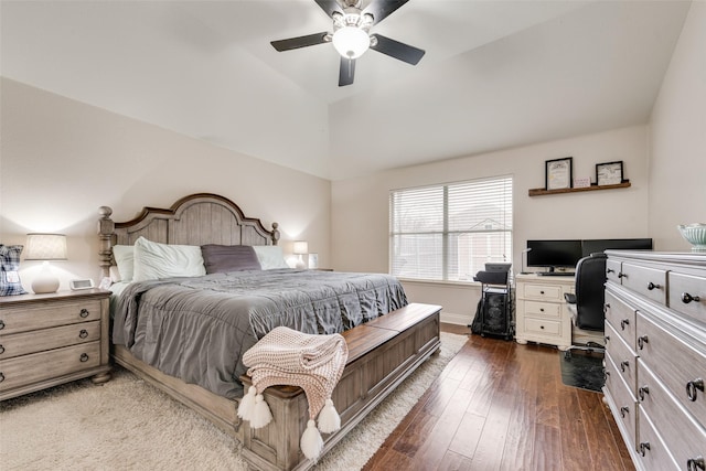 bedroom featuring lofted ceiling, dark wood finished floors, baseboards, and ceiling fan