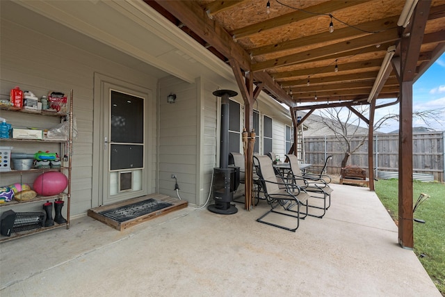 view of patio featuring a fire pit and fence