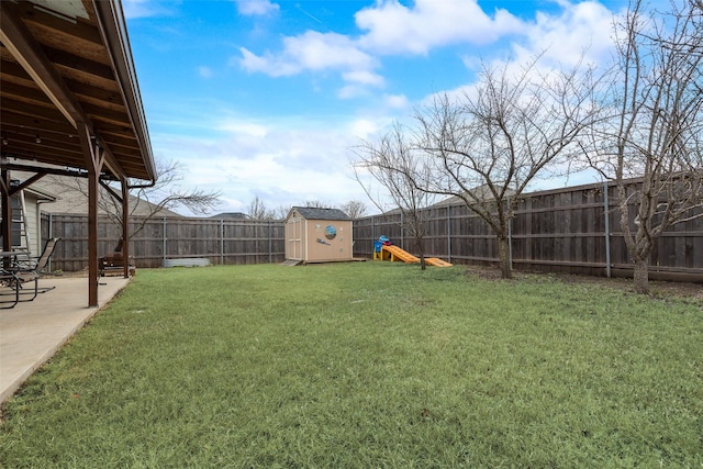 view of yard featuring an outbuilding, a patio, a shed, and a fenced backyard