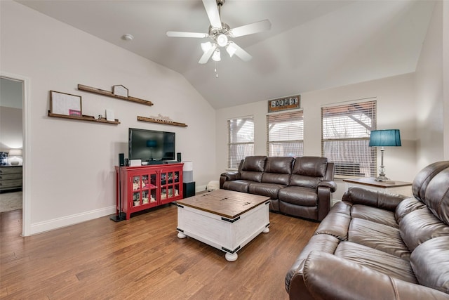 living room with a ceiling fan, baseboards, vaulted ceiling, and wood finished floors