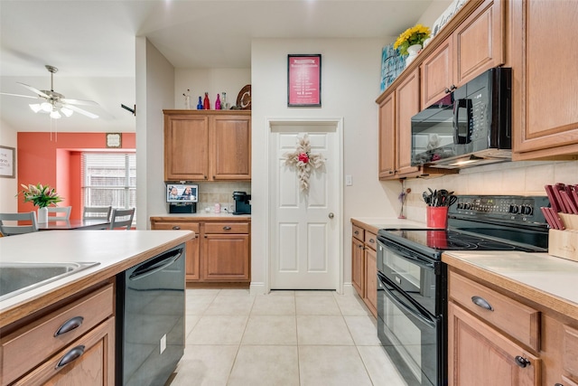 kitchen with tasteful backsplash, a ceiling fan, light countertops, black appliances, and light tile patterned flooring