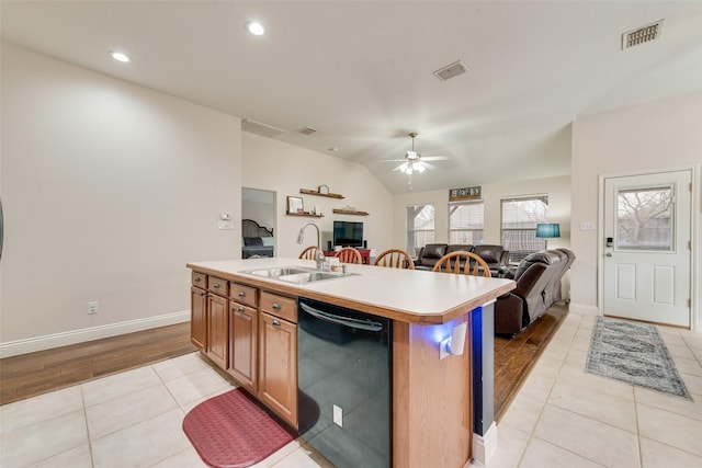 kitchen with black dishwasher, open floor plan, a sink, and visible vents