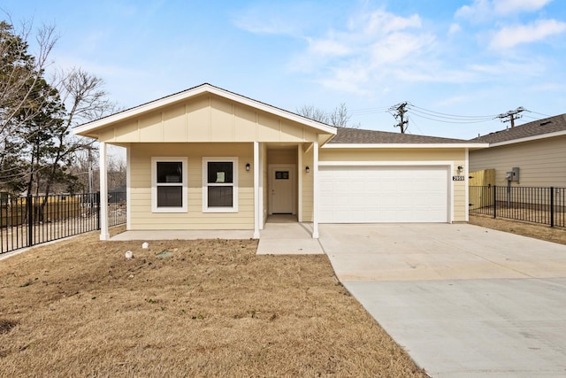 single story home featuring a garage, concrete driveway, board and batten siding, and fence