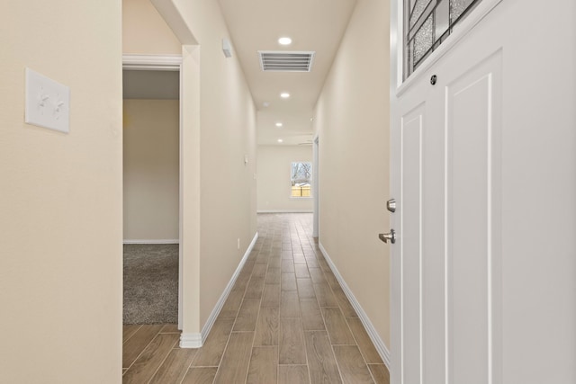 corridor featuring baseboards, recessed lighting, visible vents, and wood tiled floor