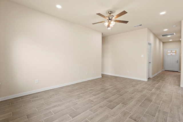 unfurnished room with recessed lighting, baseboards, visible vents, and light wood finished floors