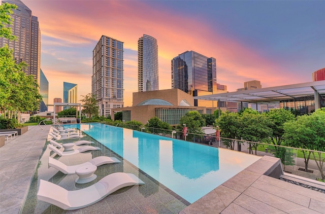 pool at dusk with a view of city