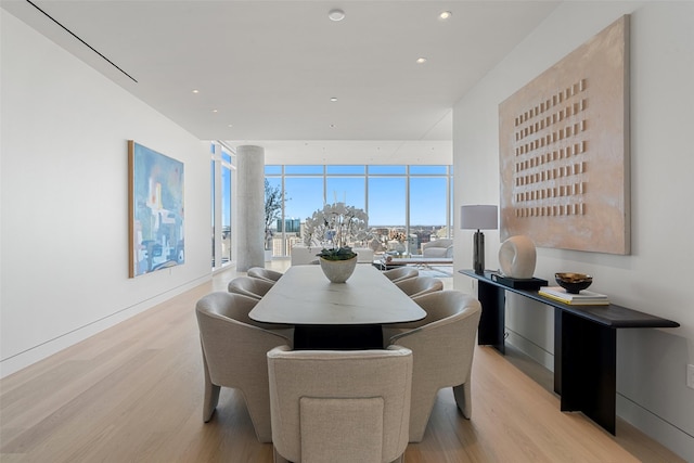 dining space with light wood-style floors, expansive windows, and recessed lighting