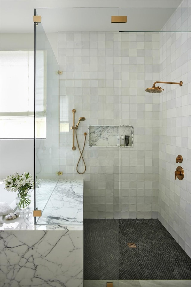 bathroom with tiled shower