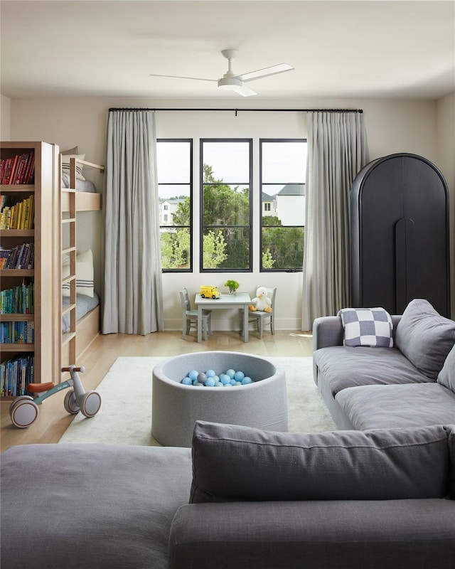 living area featuring wood finished floors and a ceiling fan