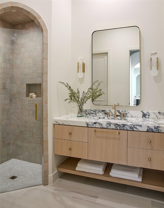 full bath with a shower stall and vanity