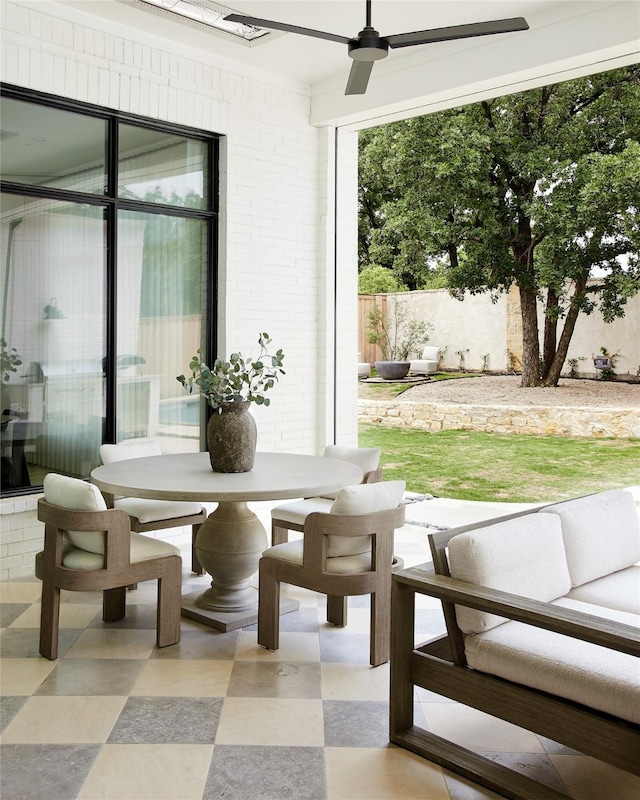 interior space with ceiling fan, an outdoor hangout area, and fence