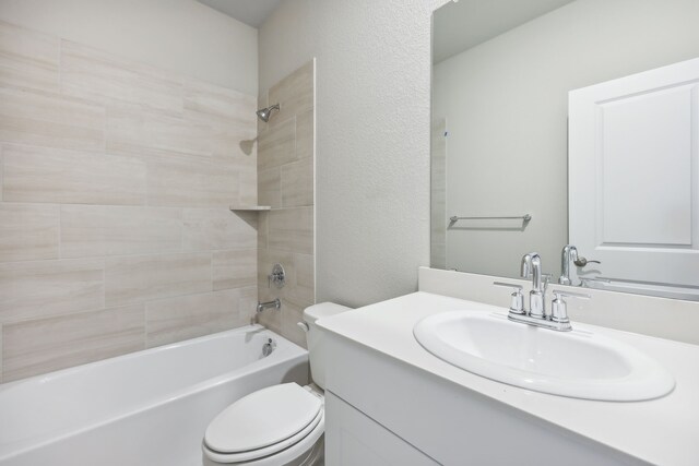 full bathroom featuring vanity, shower / bathing tub combination, toilet, and a textured wall