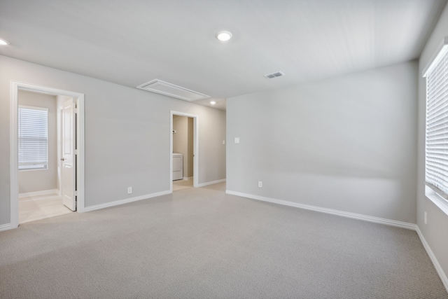 unfurnished room with visible vents, light carpet, recessed lighting, baseboards, and attic access