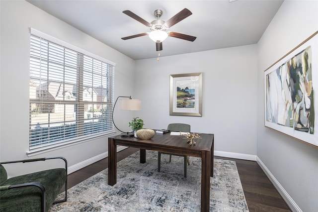 office space with ceiling fan, dark wood finished floors, and baseboards