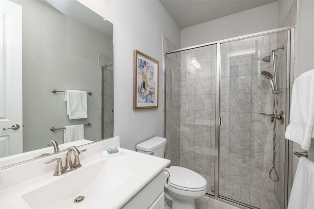 full bathroom featuring toilet, a shower stall, and vanity