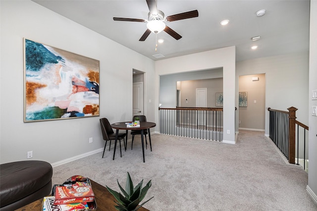 sitting room with carpet floors, recessed lighting, an upstairs landing, and baseboards