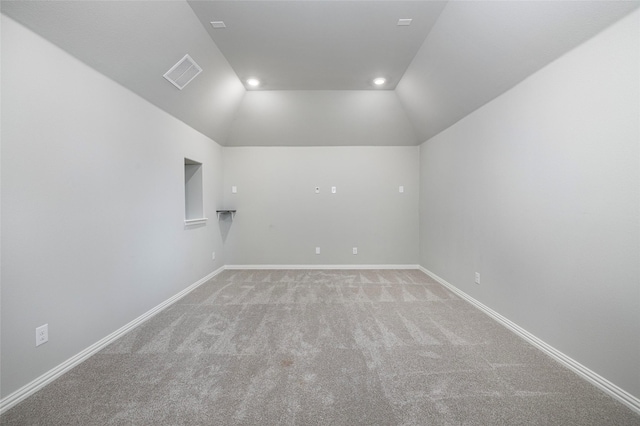 unfurnished room featuring baseboards, visible vents, light colored carpet, vaulted ceiling, and recessed lighting