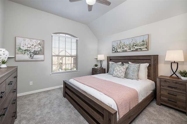 carpeted bedroom with baseboards, vaulted ceiling, and a ceiling fan