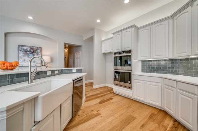 kitchen featuring light wood-style floors, appliances with stainless steel finishes, and light countertops