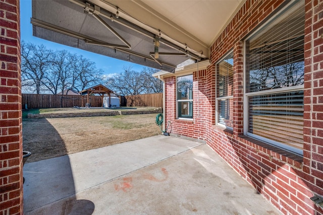 view of patio featuring a fenced backyard and an outdoor structure