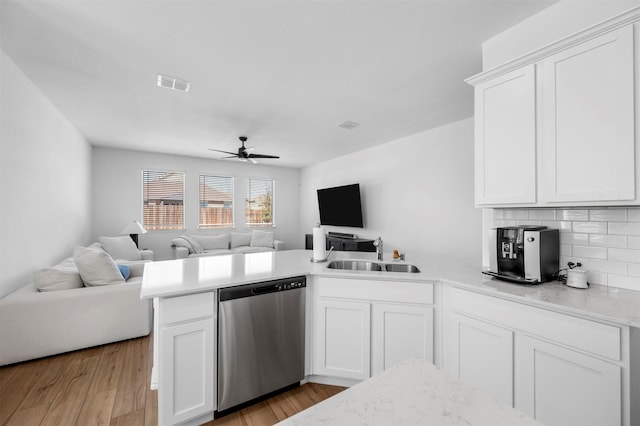 kitchen with open floor plan, visible vents, a peninsula, and stainless steel dishwasher