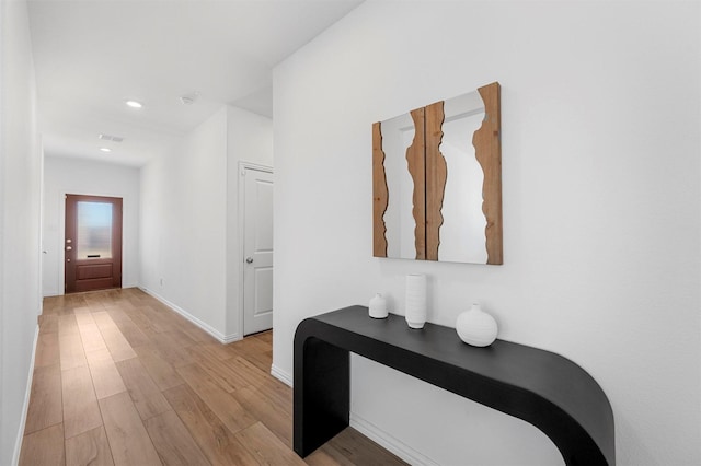 corridor with recessed lighting, light wood-style flooring, and baseboards