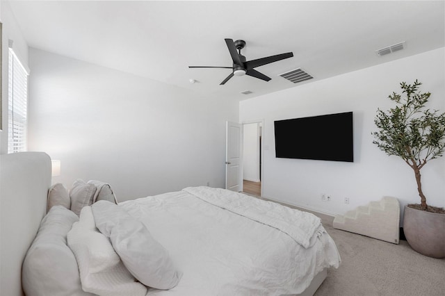 bedroom with light carpet, ceiling fan, and visible vents