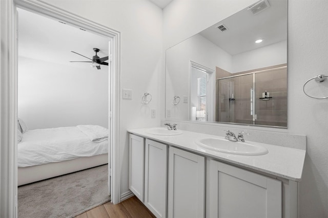 bathroom with a shower stall, visible vents, a sink, and ensuite bathroom