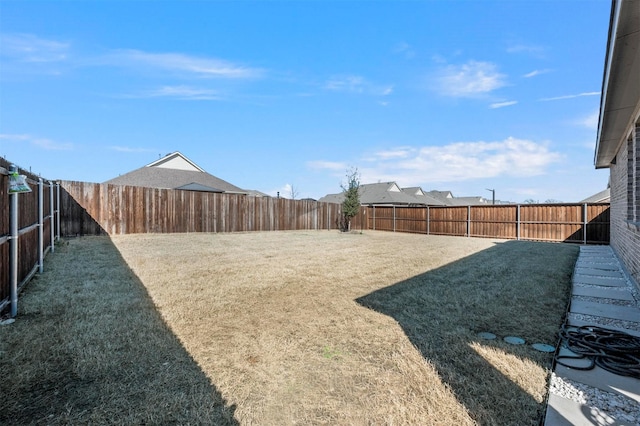 view of yard featuring a fenced backyard