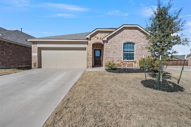 ranch-style home featuring a garage, concrete driveway, brick siding, and a front yard