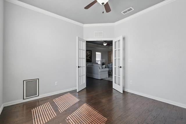 spare room with french doors, wood finished floors, visible vents, and crown molding