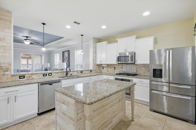 kitchen featuring visible vents, appliances with stainless steel finishes, decorative backsplash, and a sink