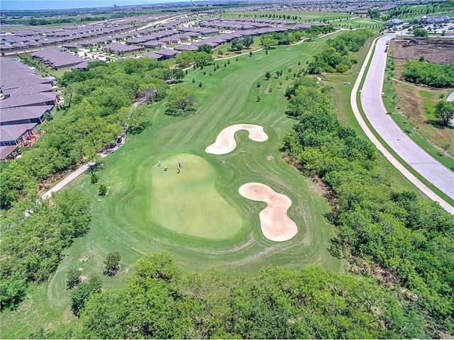 birds eye view of property with view of golf course and a residential view