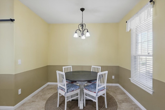 dining room with an inviting chandelier, tile patterned flooring, and baseboards