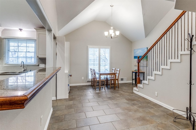 unfurnished dining area with lofted ceiling, a sink, visible vents, stairway, and an inviting chandelier