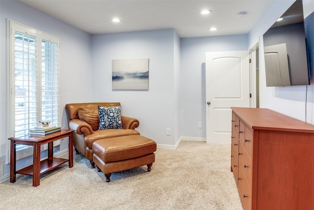 sitting room featuring light carpet, plenty of natural light, and recessed lighting