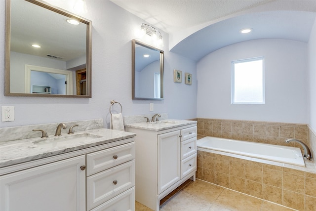 bathroom featuring tile patterned flooring, two vanities, a sink, and visible vents