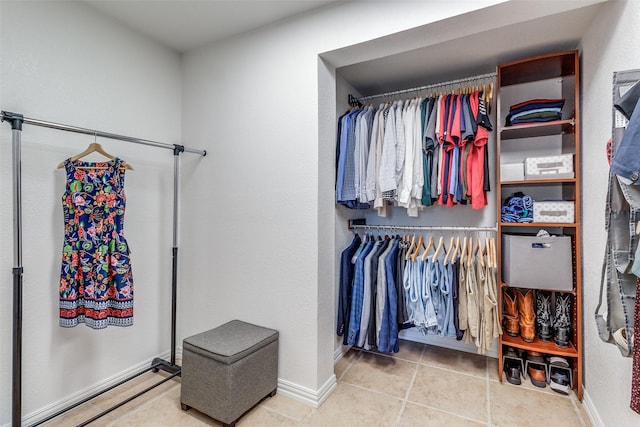 walk in closet with tile patterned floors