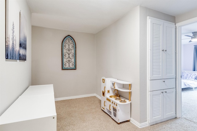 playroom with light carpet and baseboards