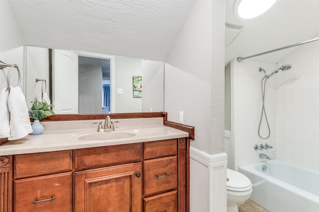 bathroom featuring toilet, lofted ceiling, tub / shower combination, a textured ceiling, and vanity