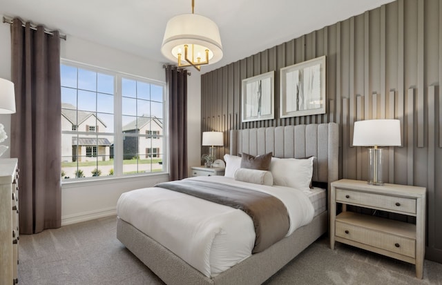 carpeted bedroom with baseboards and a notable chandelier