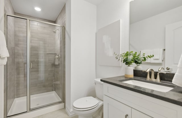 full bathroom featuring toilet, a shower stall, and vanity