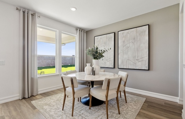 dining area featuring recessed lighting, wood finished floors, and baseboards