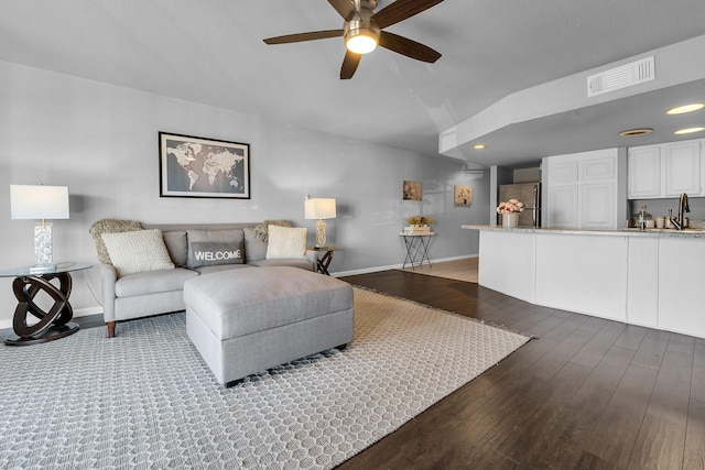 living room with recessed lighting, visible vents, a ceiling fan, wood finished floors, and baseboards